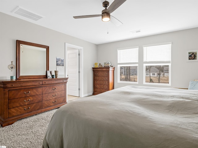 bedroom with ceiling fan, visible vents, and light colored carpet