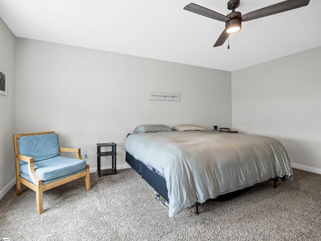 bedroom with a ceiling fan, carpet flooring, and baseboards