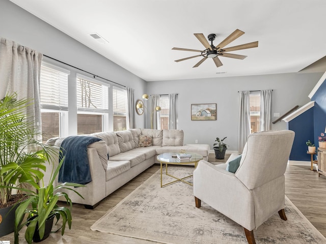 living room featuring ceiling fan, wood finished floors, and visible vents