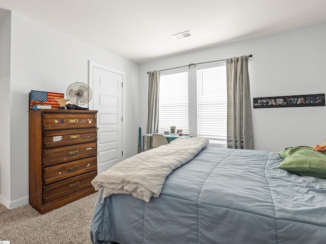 carpeted bedroom featuring visible vents