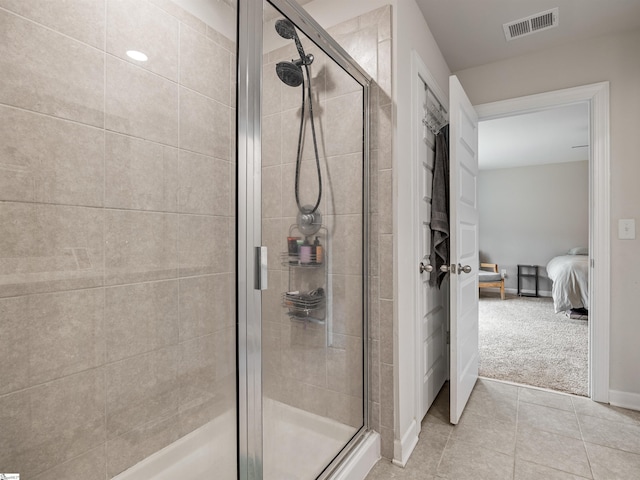 full bath featuring ensuite bathroom, a stall shower, visible vents, and tile patterned floors