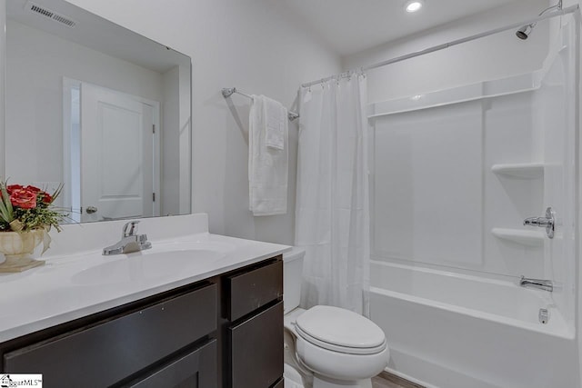 full bath featuring visible vents, shower / tub combo with curtain, vanity, and toilet