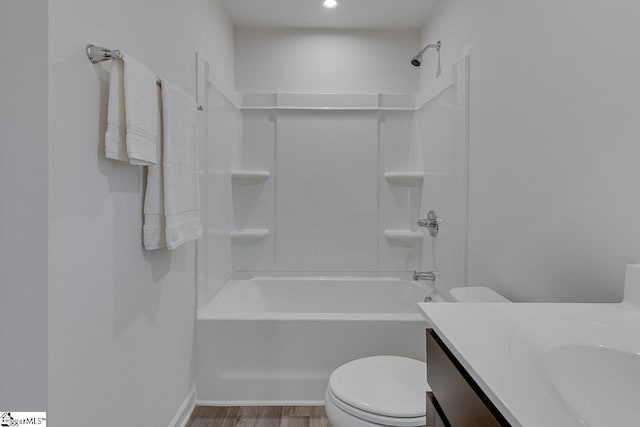 bathroom featuring toilet, bathtub / shower combination, wood finished floors, and vanity