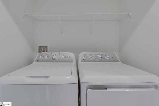 washroom featuring washing machine and dryer and laundry area