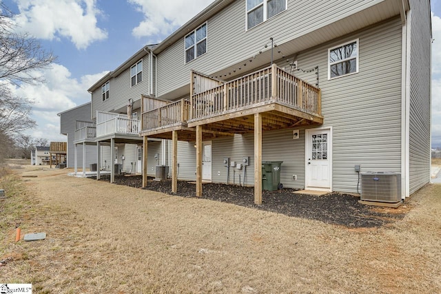 back of property with central AC and a wooden deck