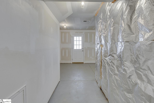 hallway featuring visible vents and concrete flooring