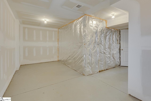 empty room with concrete floors and visible vents