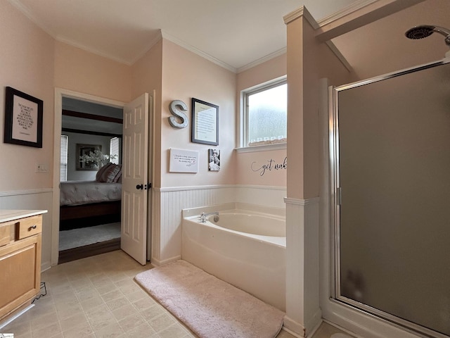 bathroom featuring a garden tub, crown molding, a stall shower, wainscoting, and ensuite bath