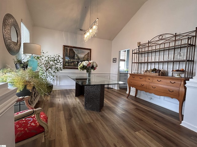 dining room featuring dark wood-style flooring, wainscoting, and plenty of natural light