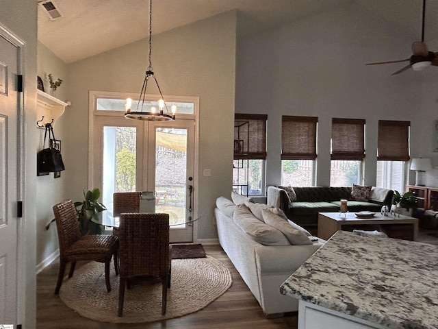 dining space with a wealth of natural light, visible vents, and dark wood-type flooring