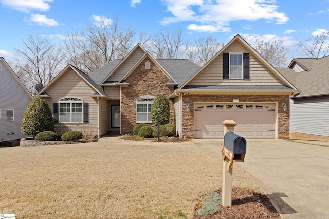 craftsman-style home featuring a shingled roof, concrete driveway, stone siding, and a garage