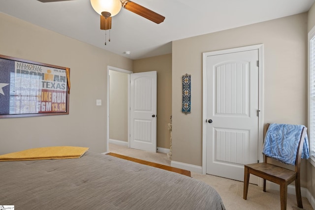 bedroom with a ceiling fan and baseboards