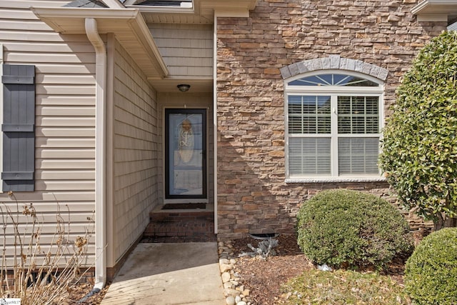 property entrance featuring stone siding