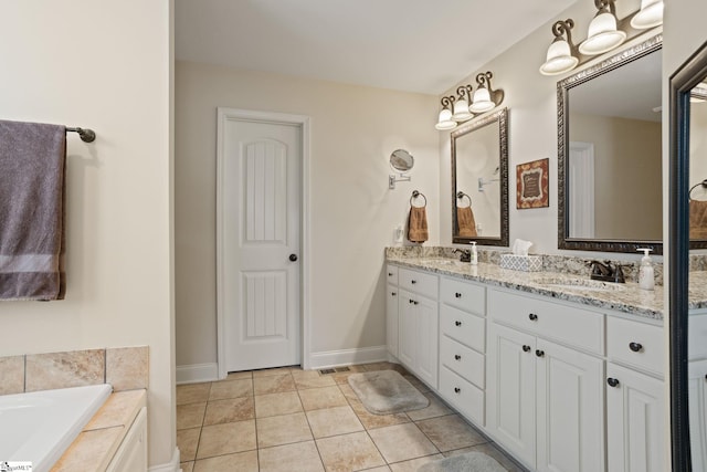 bathroom with tile patterned flooring, a sink, a bath, and double vanity