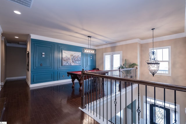 playroom featuring dark wood-style floors, visible vents, crown molding, and baseboards