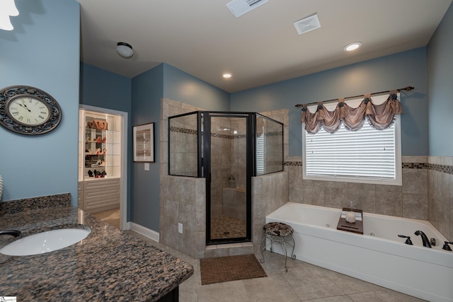 bathroom featuring a stall shower, tile patterned flooring, visible vents, and a whirlpool tub