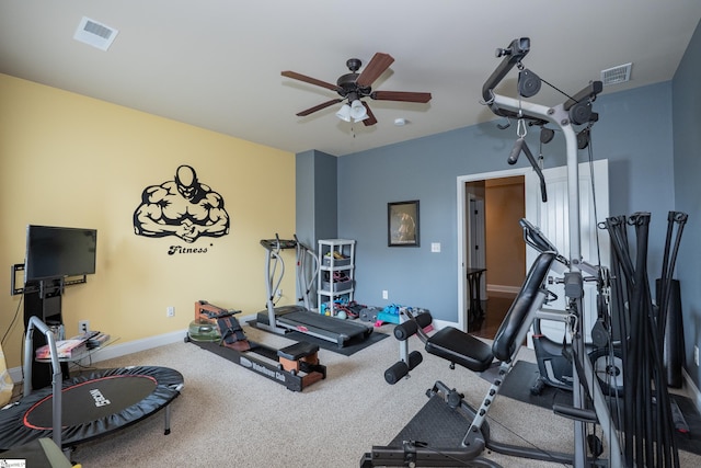 workout area featuring carpet, baseboards, visible vents, and a ceiling fan