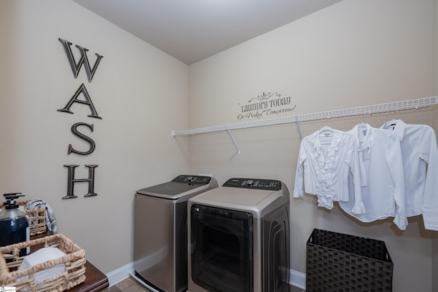 clothes washing area with laundry area, independent washer and dryer, and baseboards