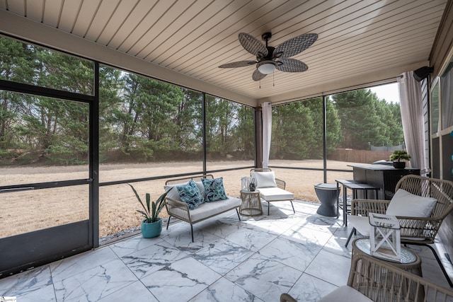 unfurnished sunroom with wood ceiling and ceiling fan