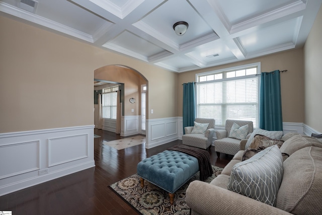 living area with dark wood-style floors, arched walkways, visible vents, coffered ceiling, and beamed ceiling