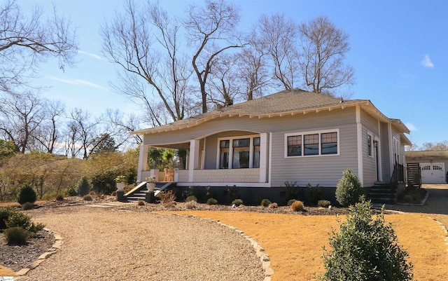 view of side of property featuring covered porch and driveway