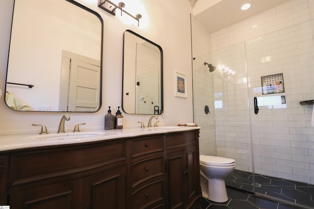 full bathroom with toilet, tile patterned flooring, a sink, and tiled shower