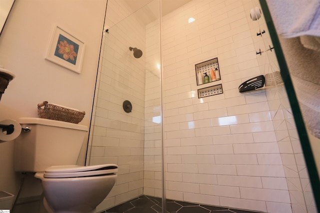 bathroom with tiled shower and toilet