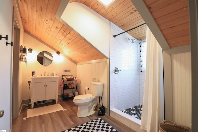 bathroom with toilet, a stall shower, wood finished floors, and lofted ceiling