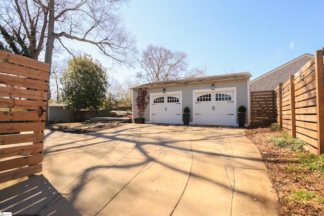 detached garage featuring fence