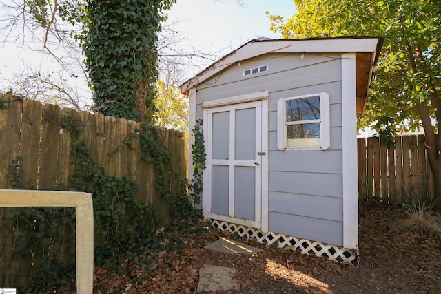 view of shed with fence