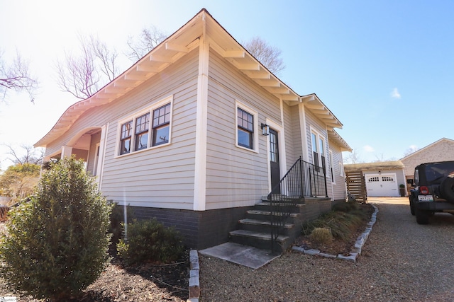 view of side of property with an outbuilding and a garage