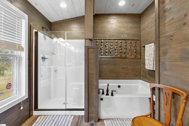 bathroom with a stall shower and wooden walls