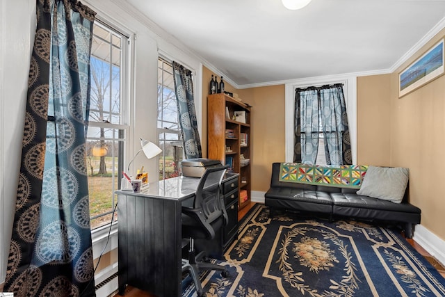 office area with baseboards, wood finished floors, and crown molding