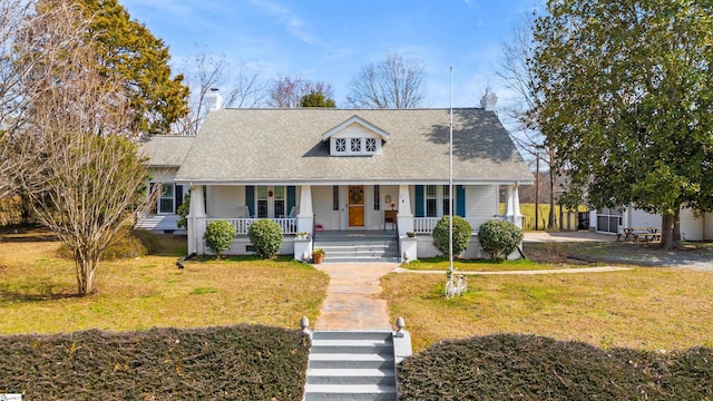 cape cod home featuring a porch, crawl space, a chimney, and a front lawn