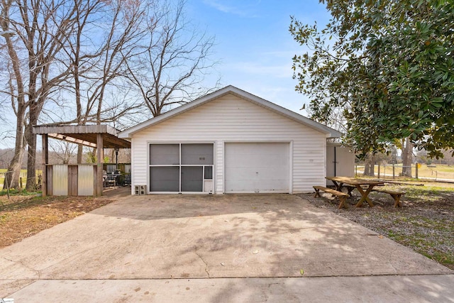 detached garage featuring fence