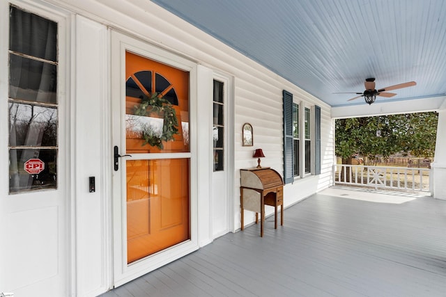 doorway to property with covered porch and ceiling fan