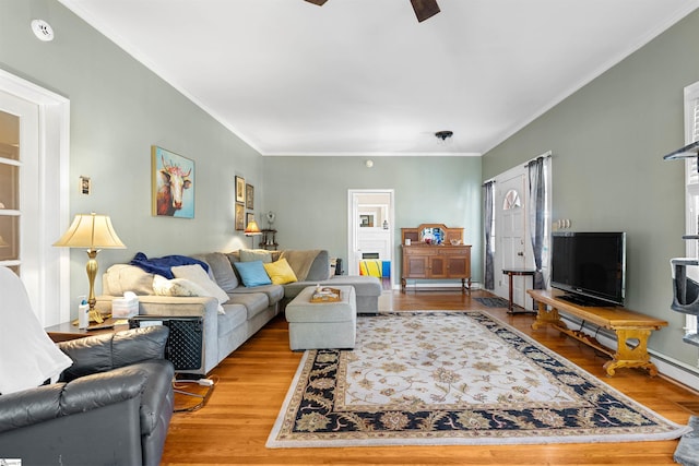 living room featuring ceiling fan, wood finished floors, and crown molding