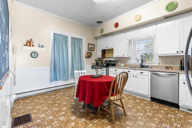 kitchen featuring a baseboard radiator, a sink, visible vents, appliances with stainless steel finishes, and wainscoting