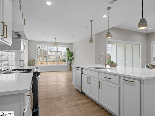 kitchen with range with electric stovetop, white cabinetry, a sink, wall chimney range hood, and dishwasher