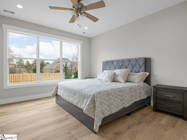 bedroom with light wood finished floors, baseboards, visible vents, and recessed lighting