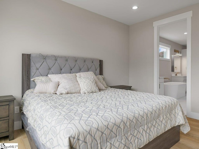 bedroom featuring recessed lighting, light wood-style flooring, and baseboards