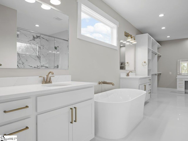 full bathroom featuring a wealth of natural light, a sink, a marble finish shower, and recessed lighting