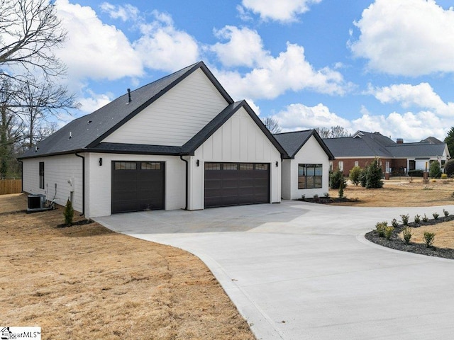 modern farmhouse style home featuring a garage, concrete driveway, board and batten siding, and cooling unit