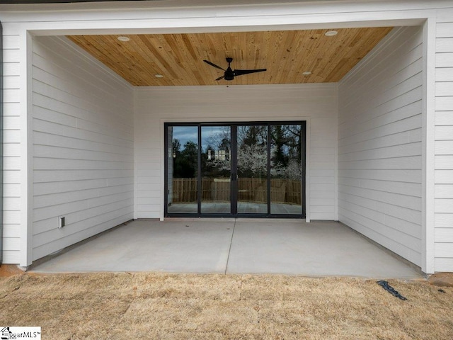 view of exterior entry featuring a patio and ceiling fan