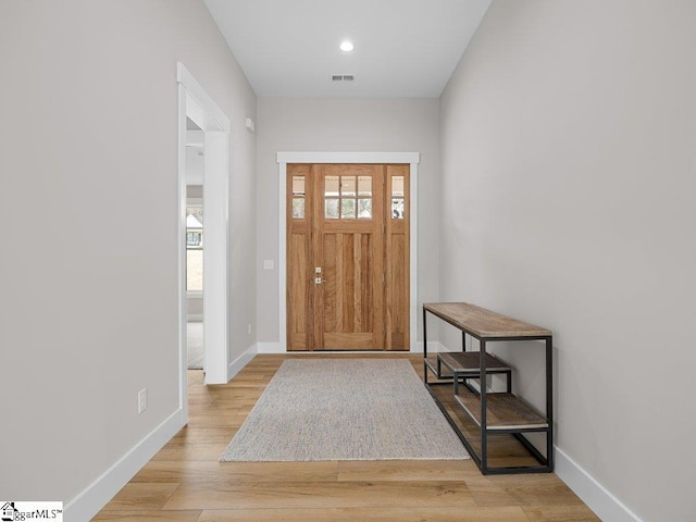 entryway featuring light wood-style flooring, visible vents, and baseboards