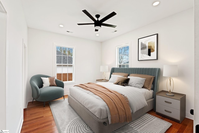 bedroom featuring recessed lighting, visible vents, baseboards, and wood finished floors