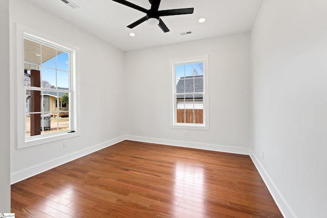 spare room with ceiling fan, recessed lighting, visible vents, baseboards, and hardwood / wood-style floors