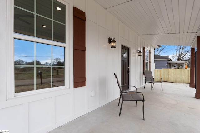 view of patio with covered porch and fence