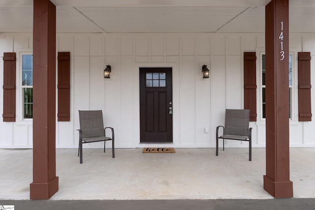 property entrance with a porch and board and batten siding