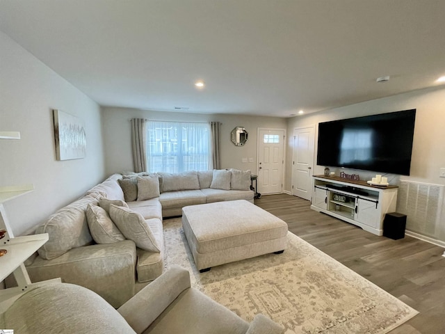 living area featuring recessed lighting, visible vents, and wood finished floors